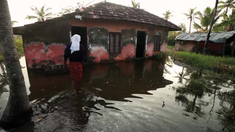 Doorsteps of houses in Munroe Island filled with water